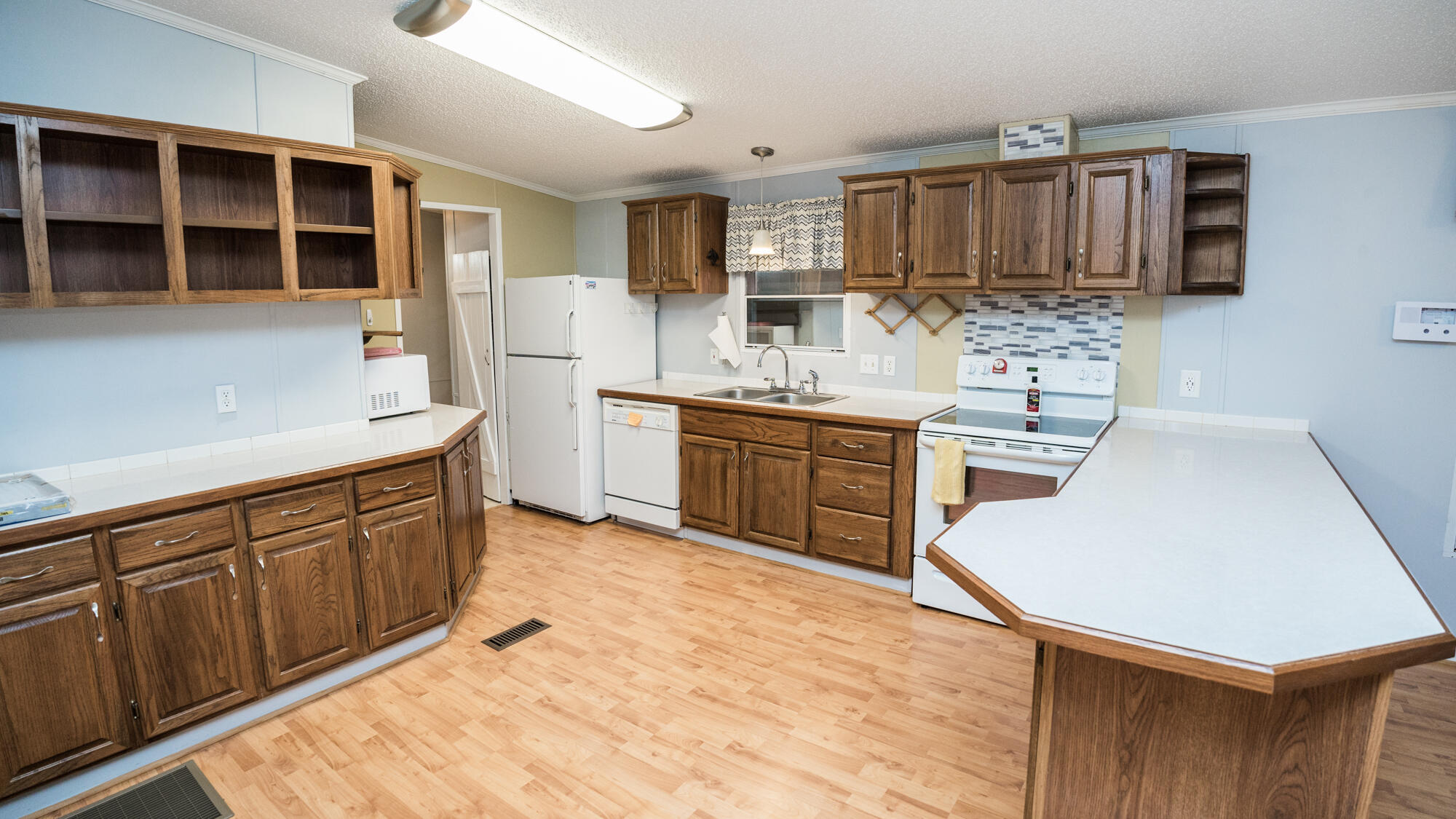 125 Red Eye Road DeFuniak Springs, FL 32433 - Photo 8 of 50 a kitchen with stainless steel appliances kitchen island granite countertop a sink dishwasher stove and cabinets with wooden floor