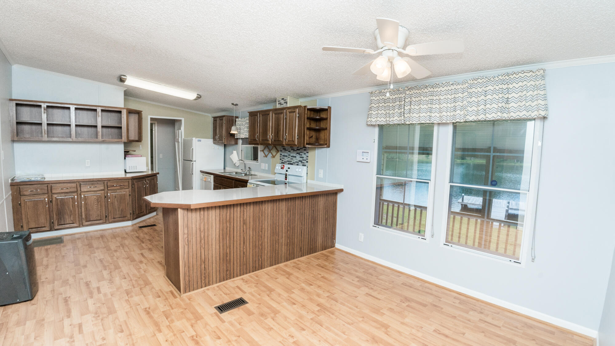 125 Red Eye Road DeFuniak Springs, FL 32433 - Photo 10 of 50 a kitchen with kitchen island granite countertop a stove top oven a sink a counter space and a window