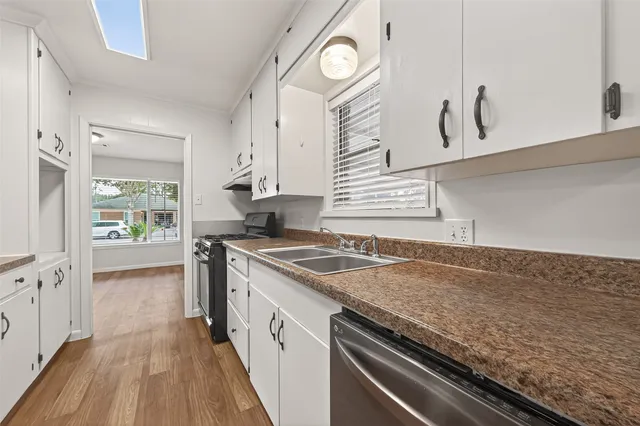 a kitchen with granite countertop a stove and a sink