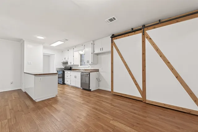 a view of kitchen with wooden floor and electronic appliances
