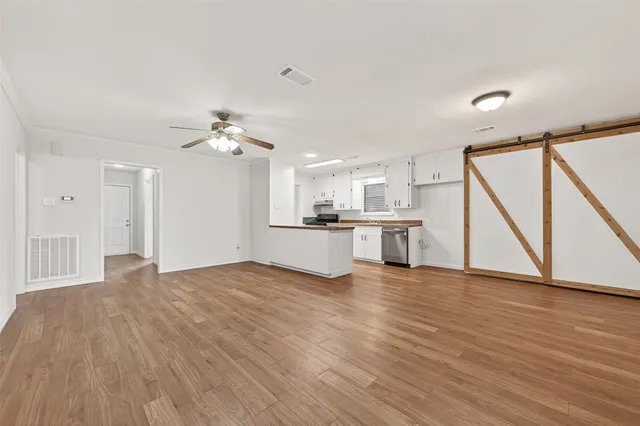 a view of a kitchen with wooden floor and a sink
