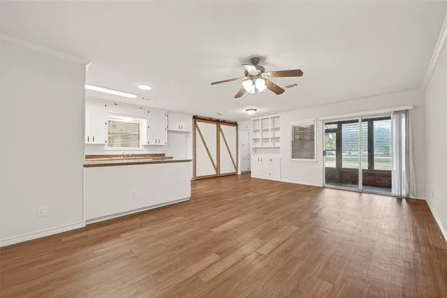 a view of an empty room with a kitchen