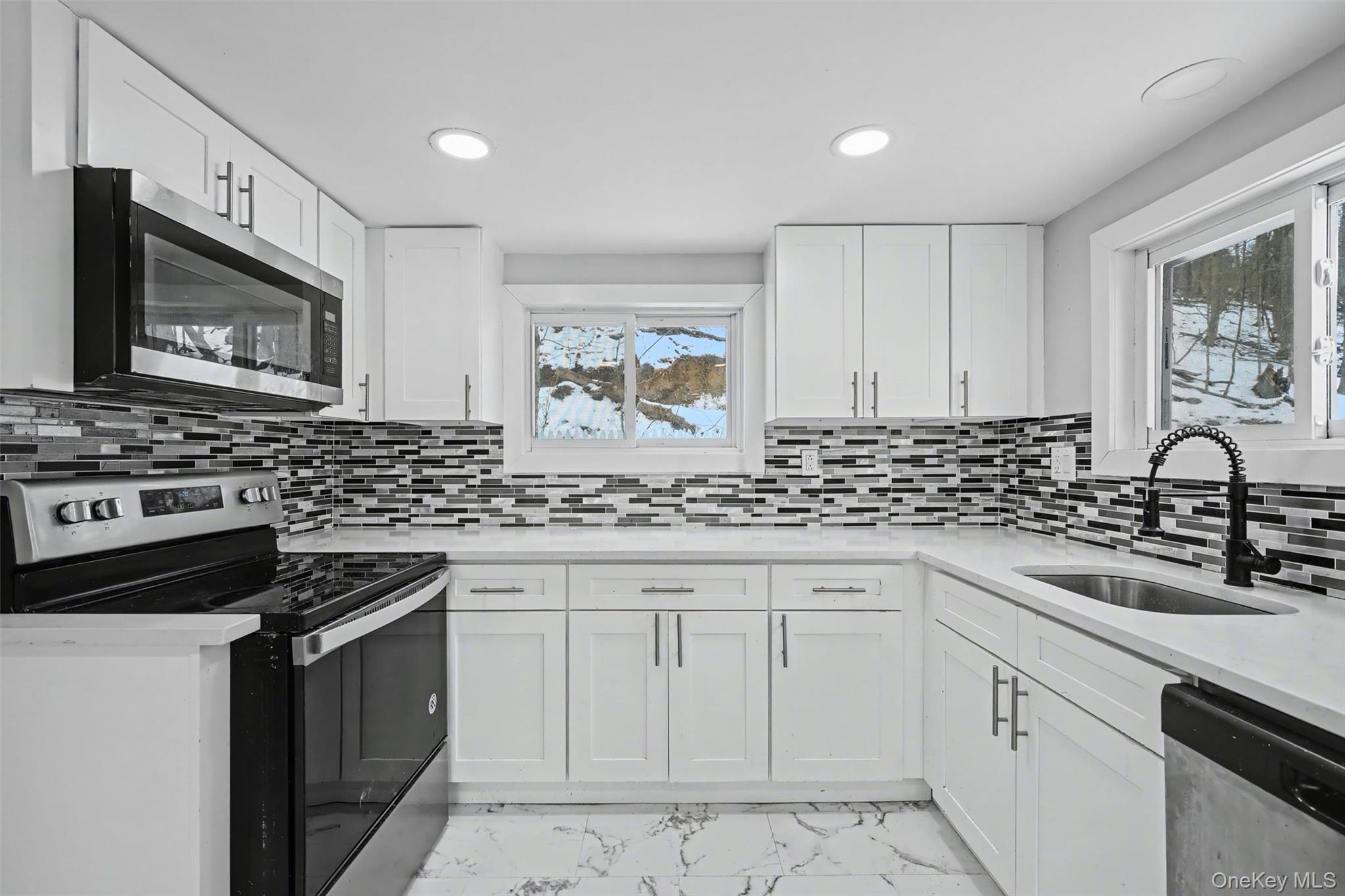 108 Pine Hill Road Chester, NY 10918 - Photo 15 of 37 a kitchen with white cabinets and appliances