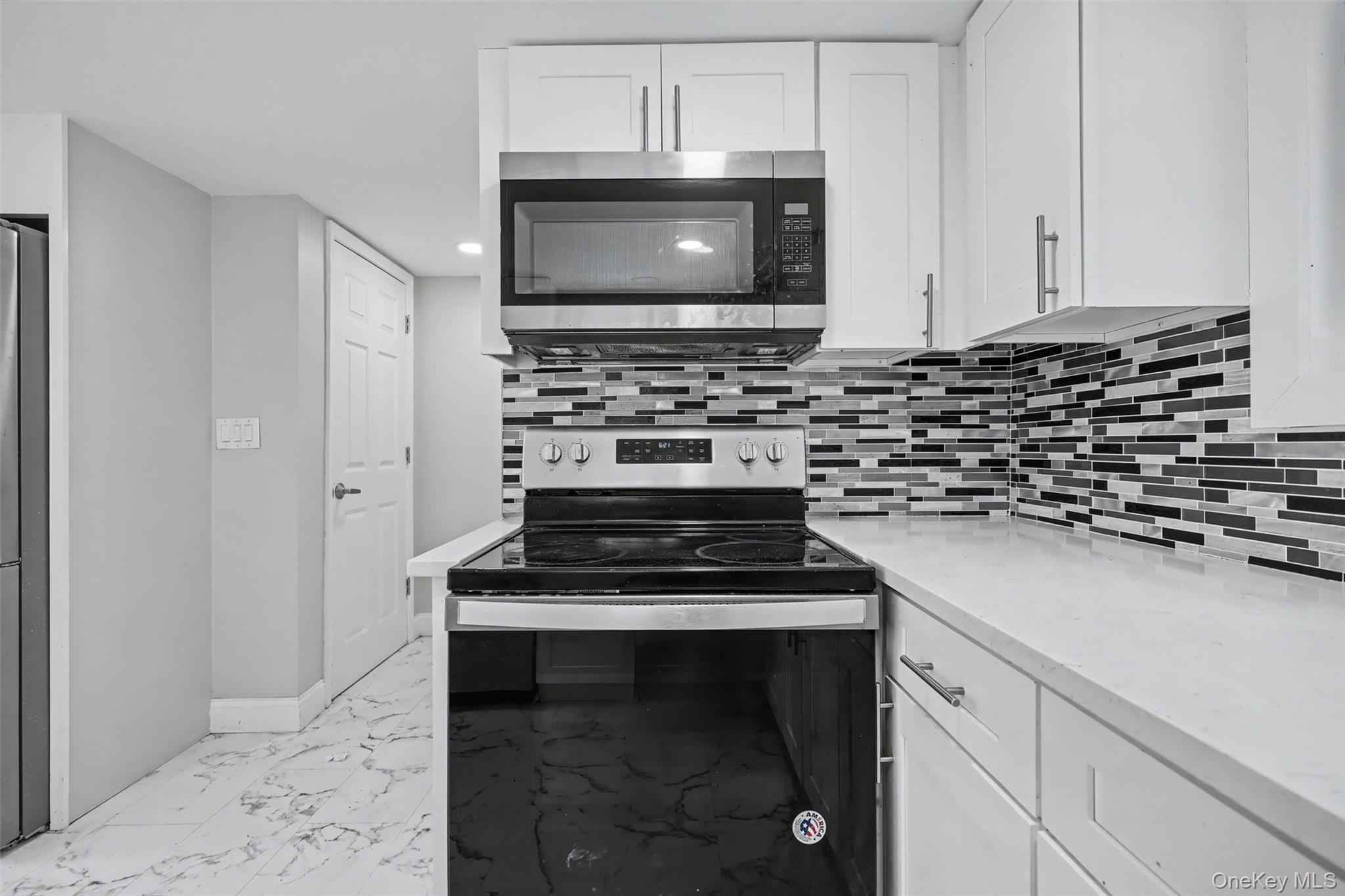108 Pine Hill Road Chester, NY 10918 - Photo 17 of 37 a kitchen with granite countertop a stove and a microwave