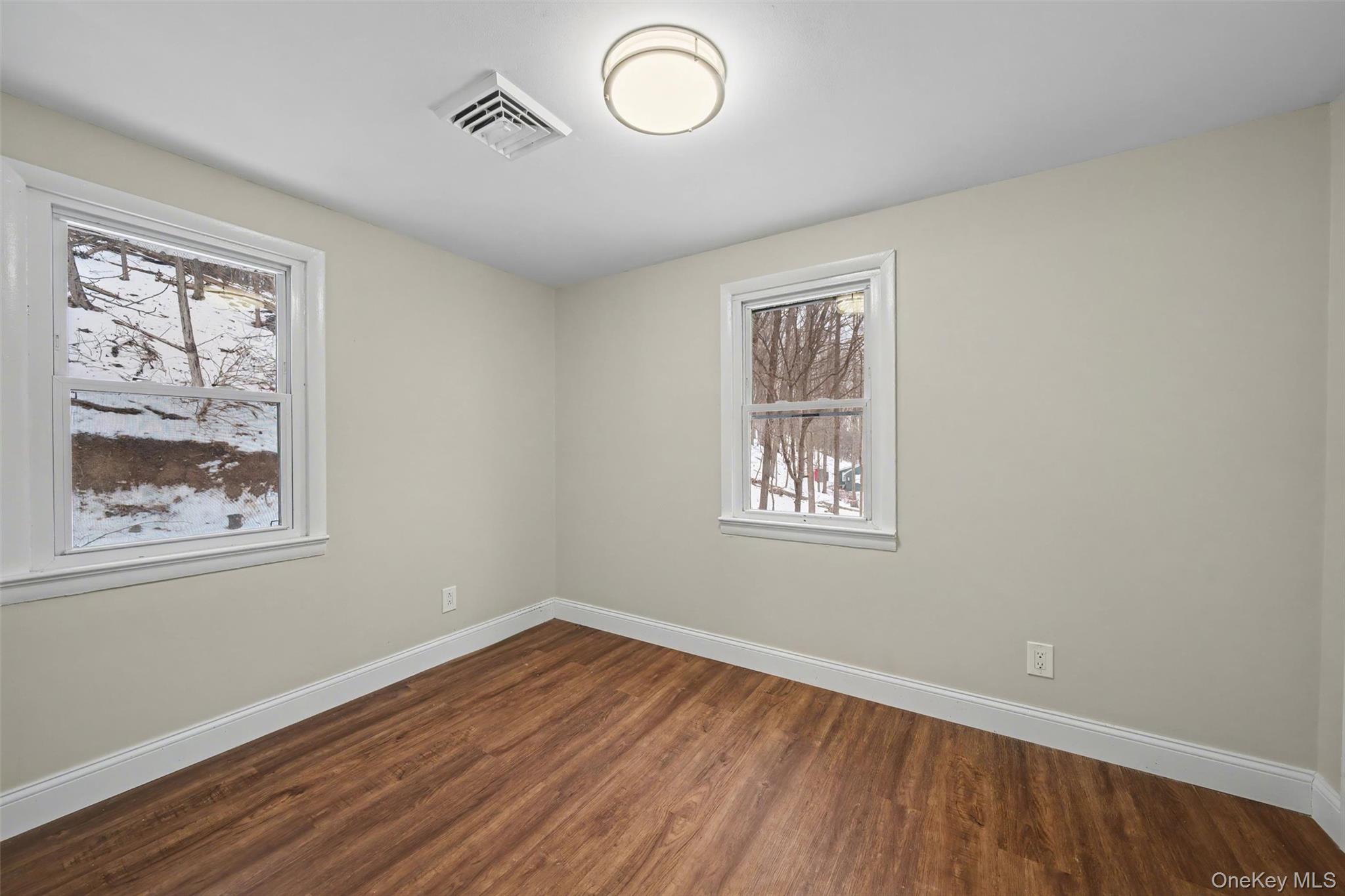 108 Pine Hill Road Chester, NY 10918 - Photo 23 of 37 a view of an empty room with wooden floor and a window