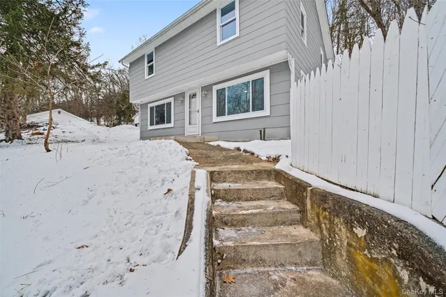 a view of a house with a snow on the road
