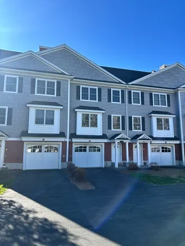 a front view of residential houses with yard