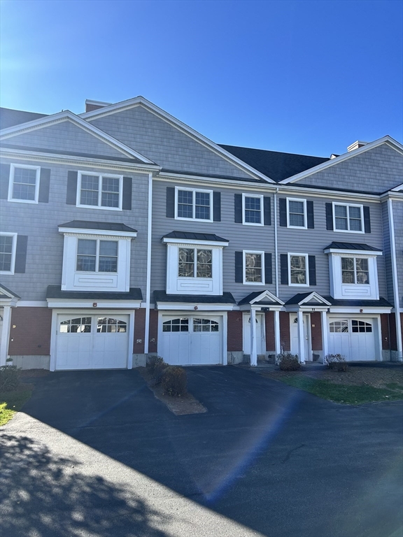 a front view of residential houses with yard
