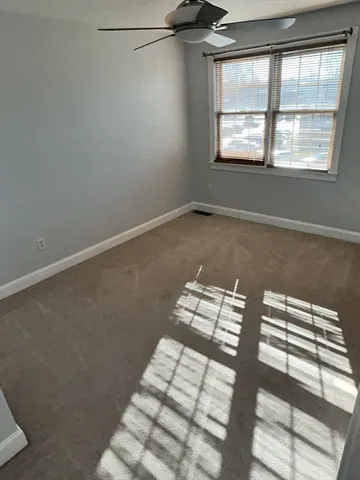 a view of a room with window and lounge chair