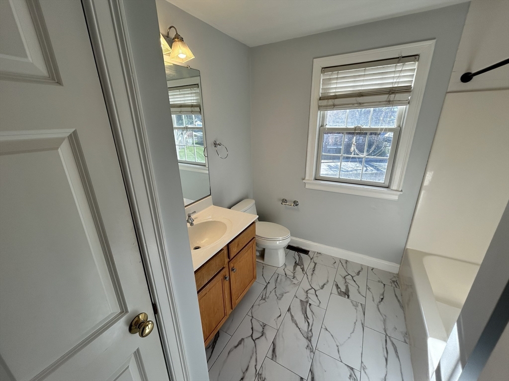 1975 Middlesex Street, Unit 10 Lowell, MA 01851 - Photo 19 of 21 a bathroom with a sink a toilet and shower
