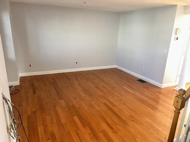 an empty room with wooden floor
