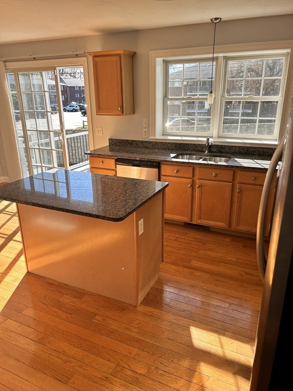 1975 Middlesex Street, Unit 10 Lowell, MA 01851 - Photo 9 of 21 a view of a kitchen with a sink and wooden floor