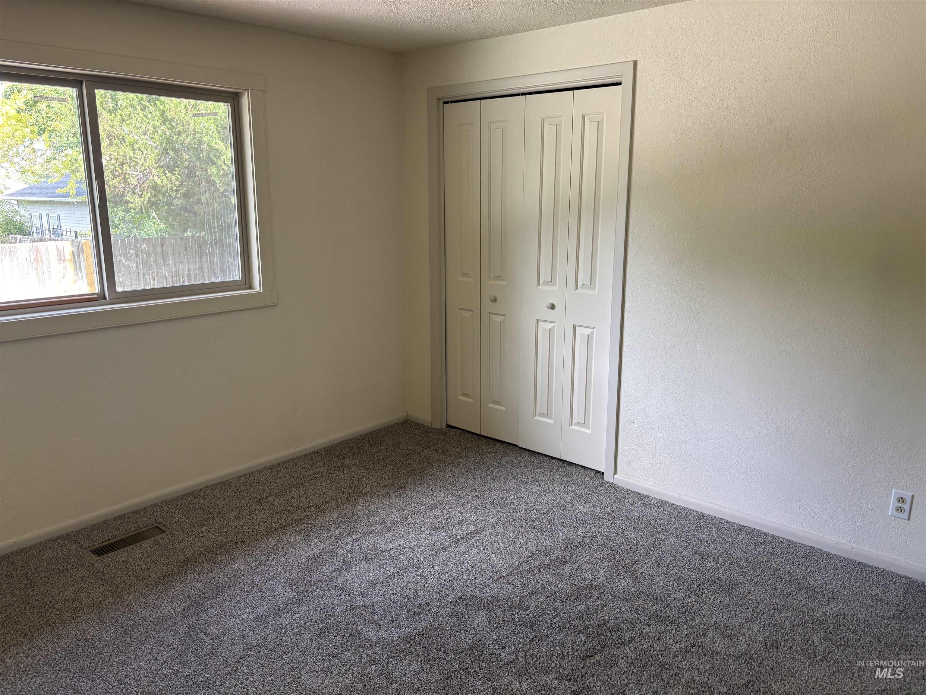513 Ridge Way Ontario, OR 97914 - Photo 19 of 29 Interior room featuring light-colored walls and dark gray carpet flooring