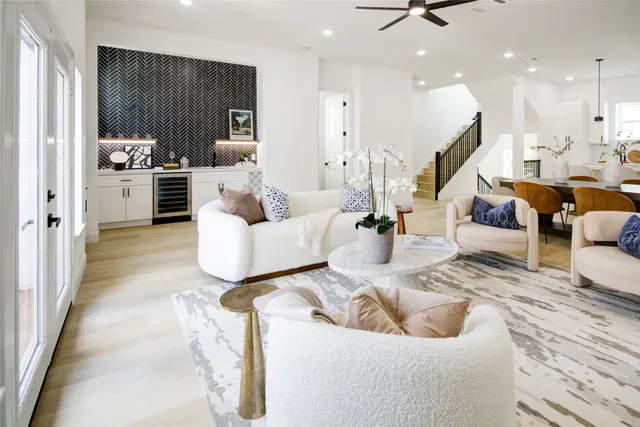 a living room with furniture and kitchen view