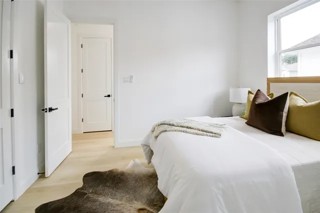 a bedroom with a bed and a bathroom