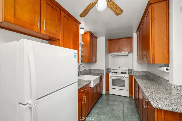 a kitchen with a refrigerator sink and stove