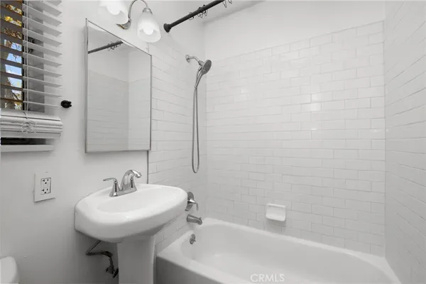a white bath tub sitting next to a white sink