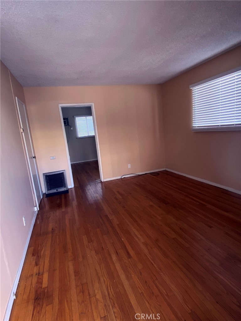 1124 Cordova Street, Unit 1 Pasadena, CA 91106 - Photo 2 of 8 a view of an empty room with wooden floor and a window