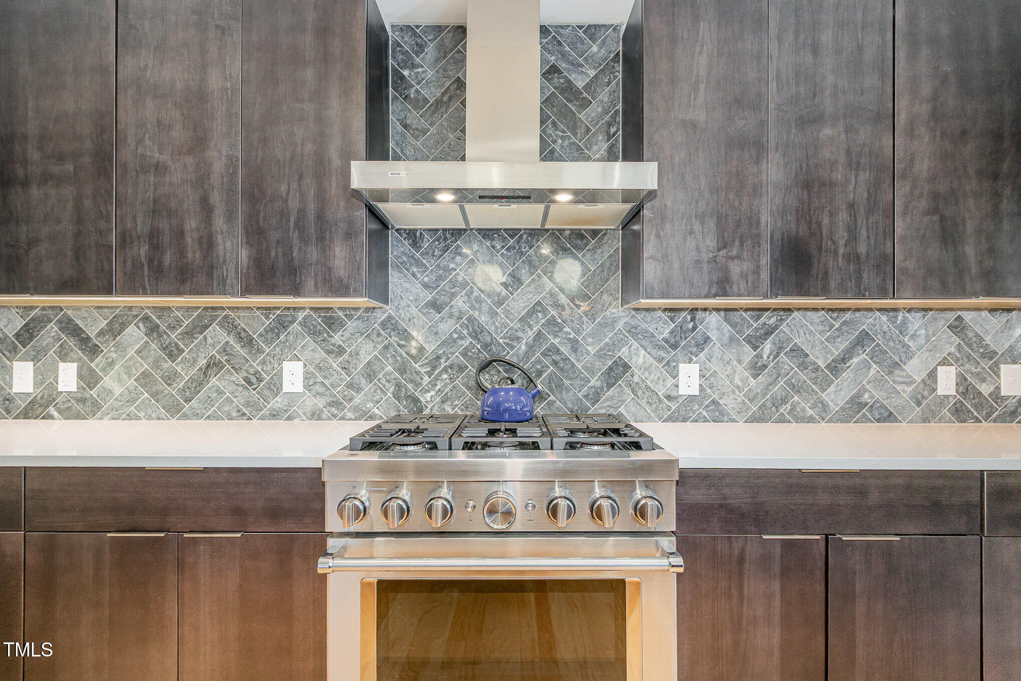 a stove top oven sitting inside of a kitchen