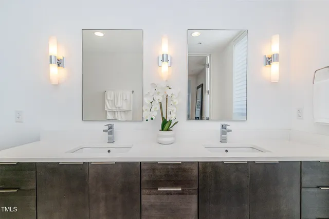 a bathroom with double sink and a mirror