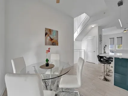 a dining room with furniture and wooden floor
