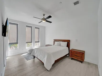 a bedroom with a large bed and a large window