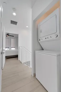 a view of a closet area with wooden floor