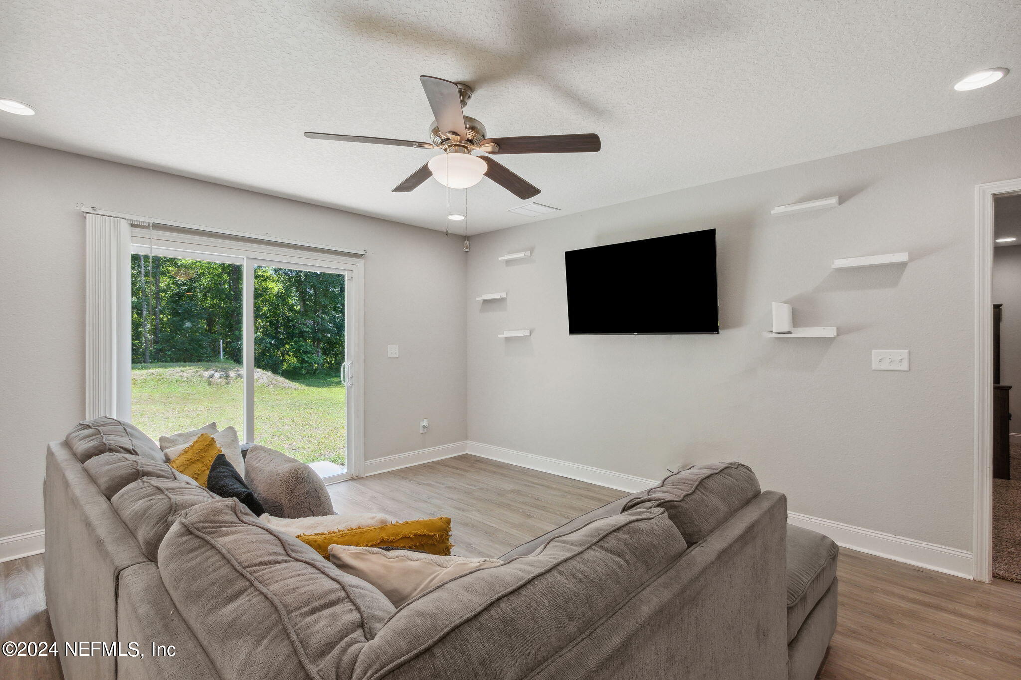 8516 April Street Jacksonville, FL 32244 - Photo 13 of 26 a living room with furniture and a flat screen tv