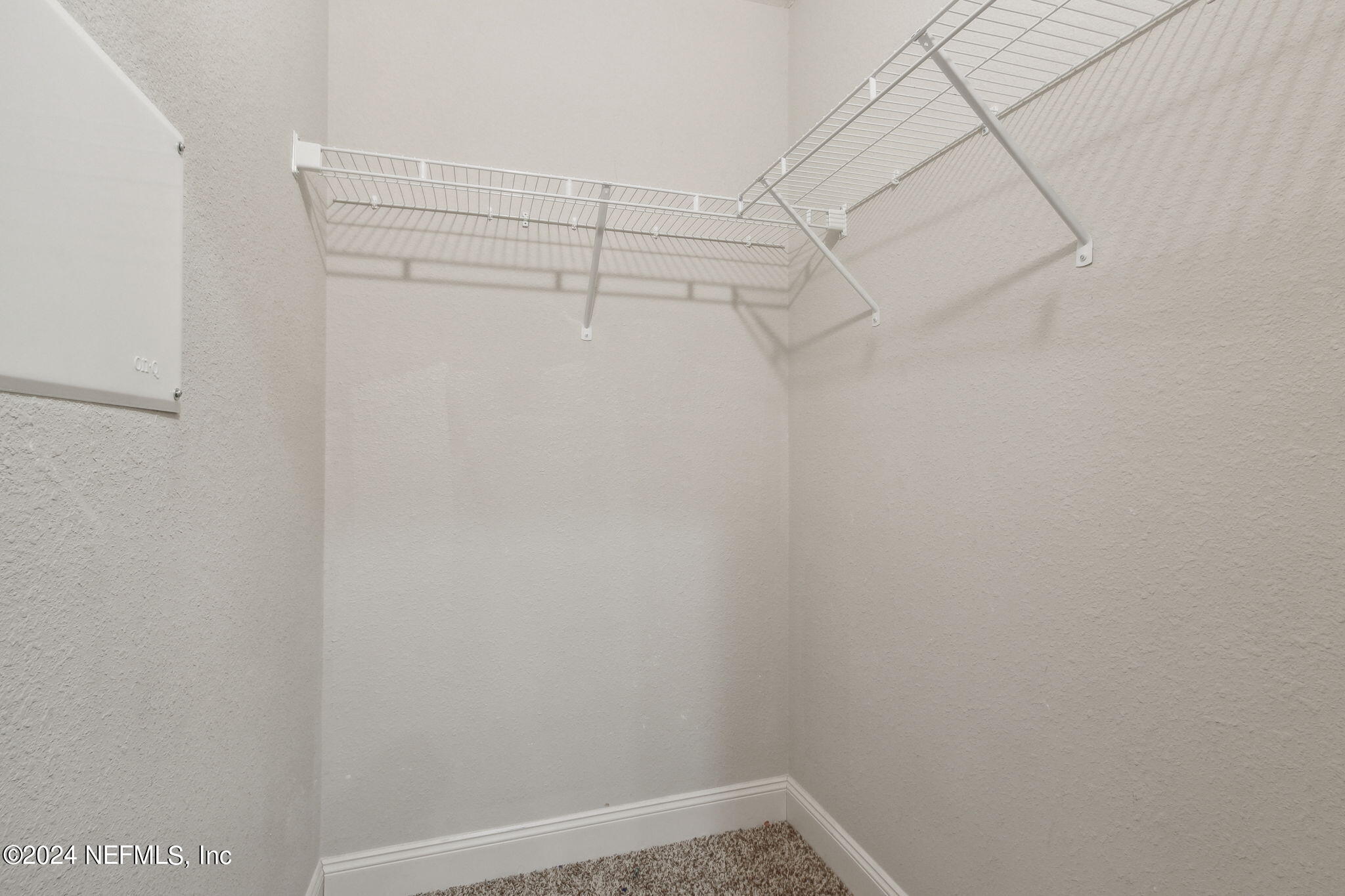 8516 April Street Jacksonville, FL 32244 - Photo 18 of 26 a view of a room with racks on the wall