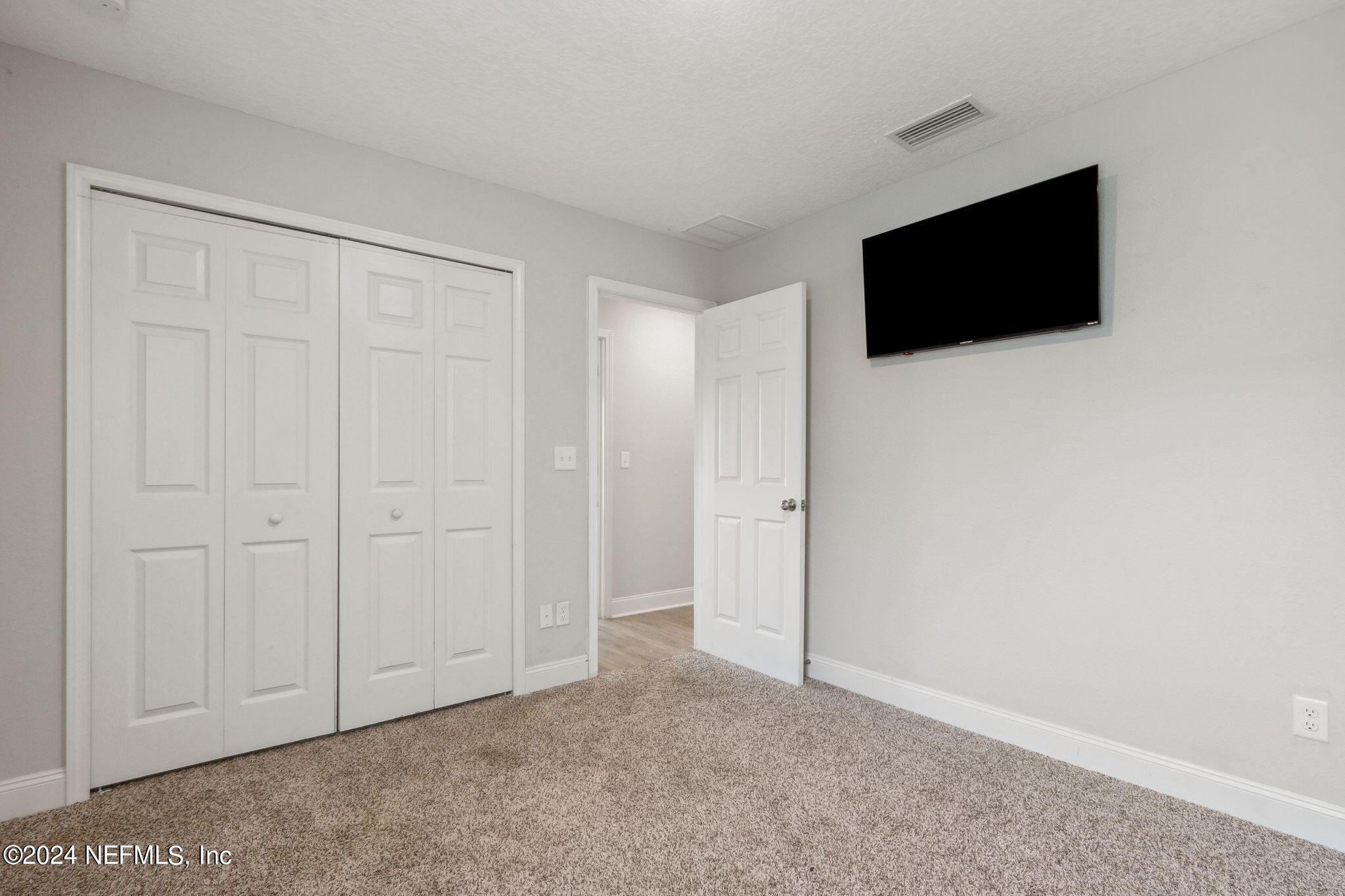 8516 April Street Jacksonville, FL 32244 - Photo 21 of 26 a view of an empty room with room and flat screen tv