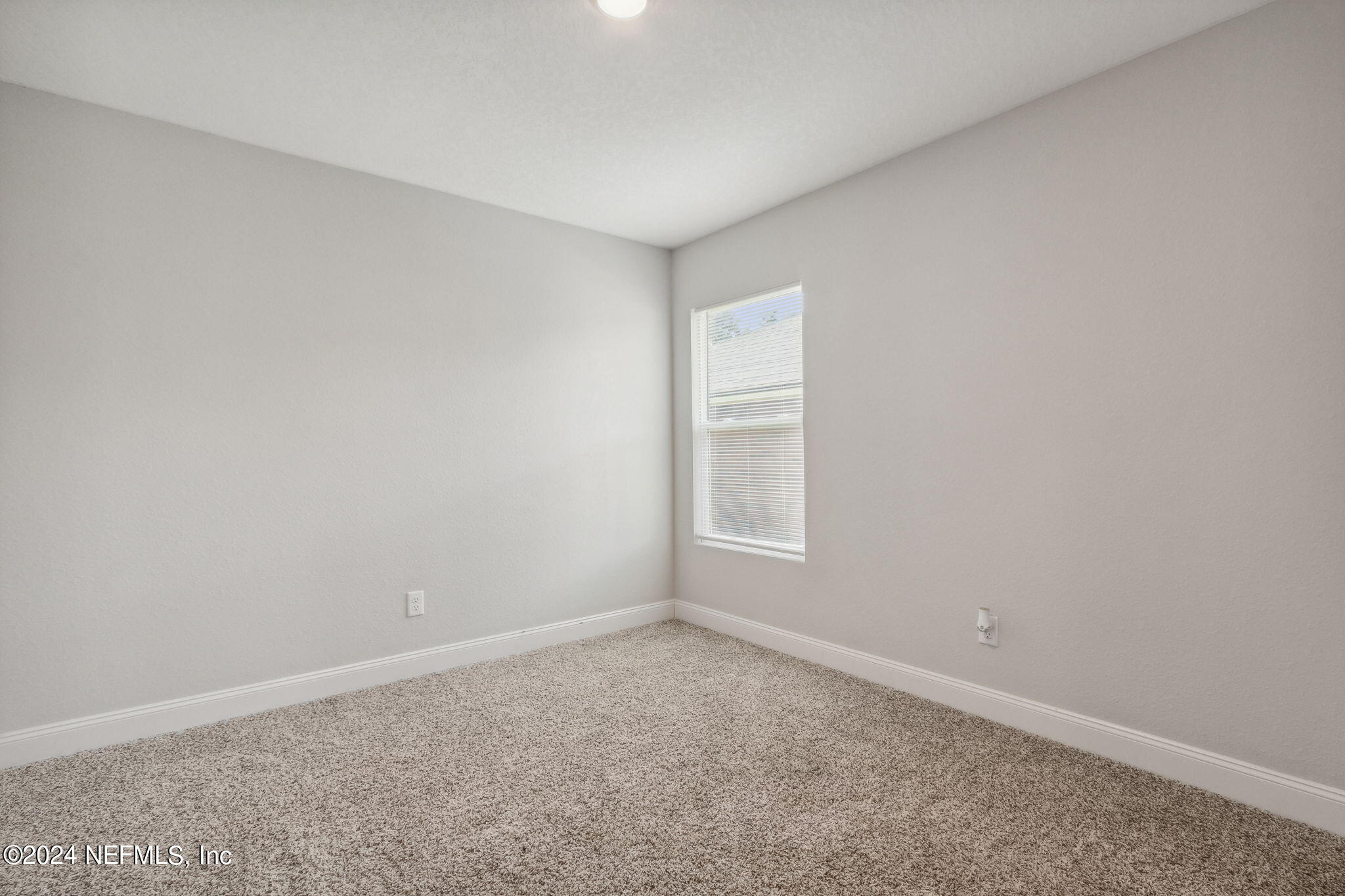 8516 April Street Jacksonville, FL 32244 - Photo 22 of 26 an empty room with a window