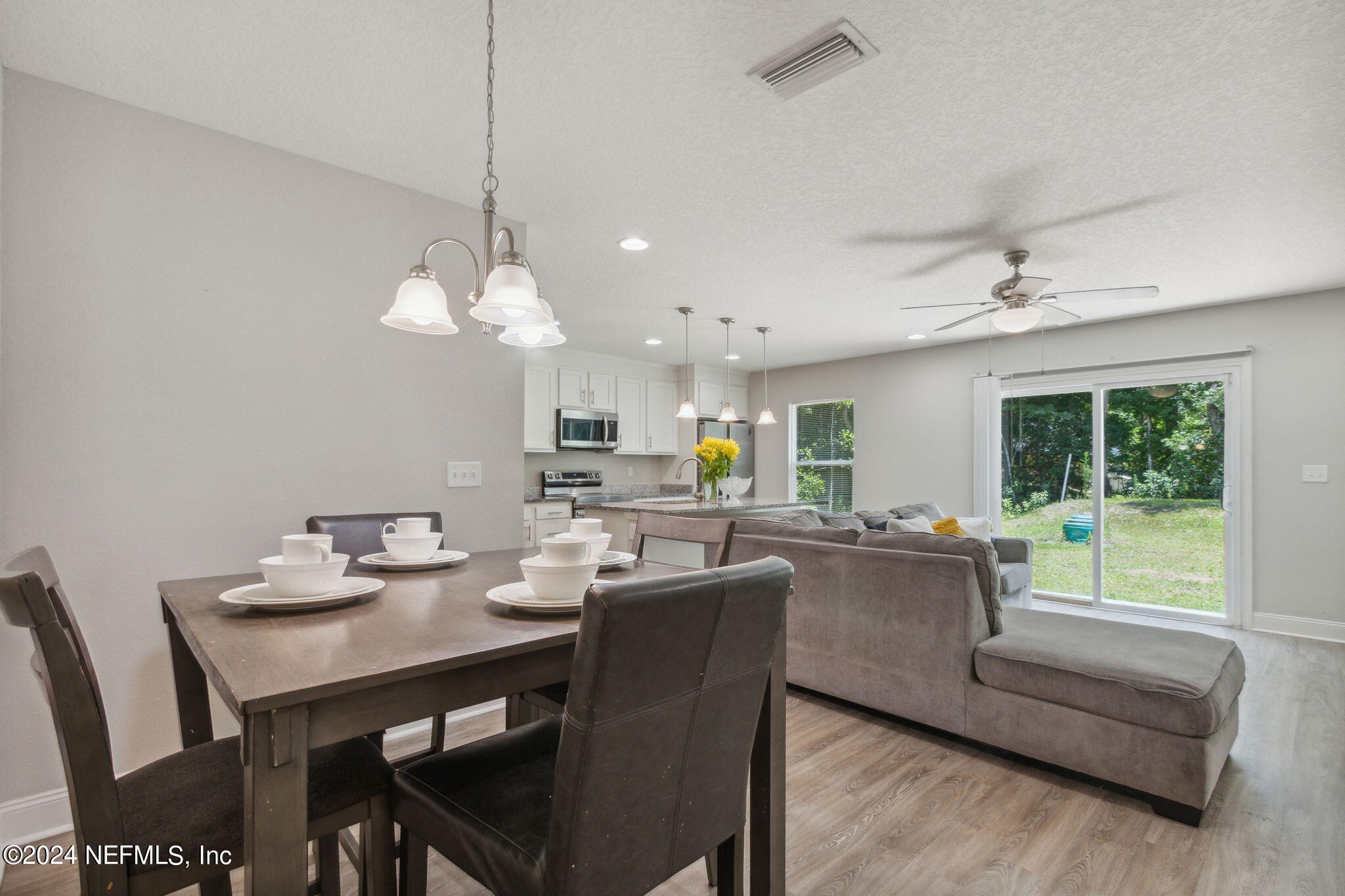 8516 April Street Jacksonville, FL 32244 - Photo 5 of 26 a dining room with furniture a chandelier and window