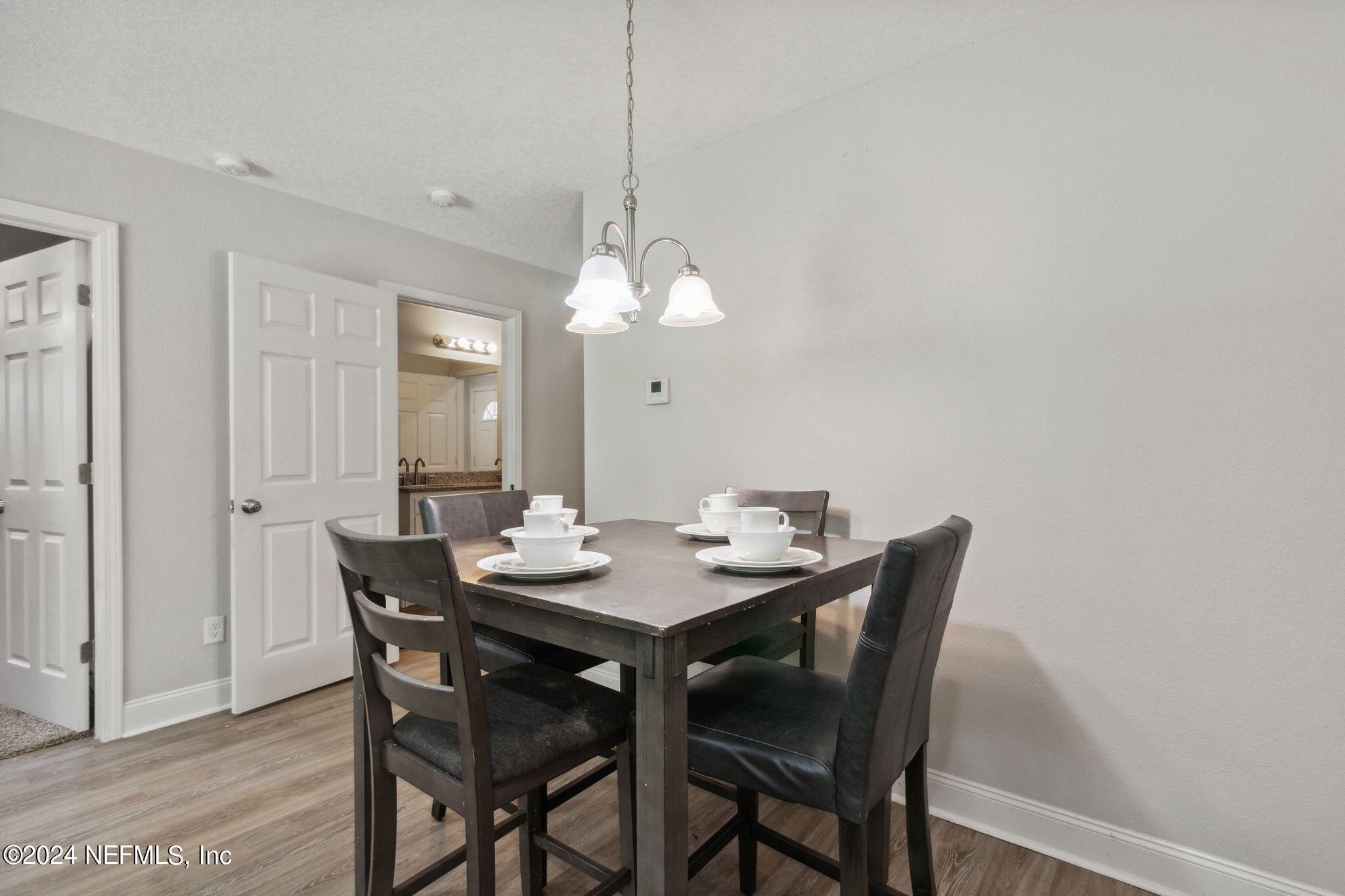 8516 April Street Jacksonville, FL 32244 - Photo 8 of 26 a dining room with a wooden table and chairs