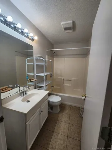 a bathroom with a double vanity sink toilet and shower