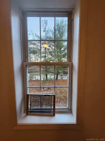 a view of a room that has a door and wooden floor