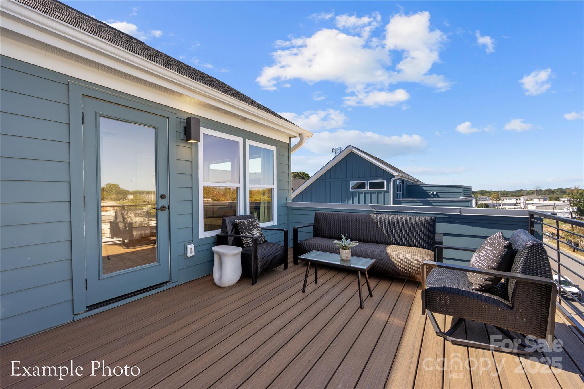 548 Rountree Road, Unit 9 Charlotte, NC 28217 - Photo 1 of 36 a roof deck with couches and wooden floor