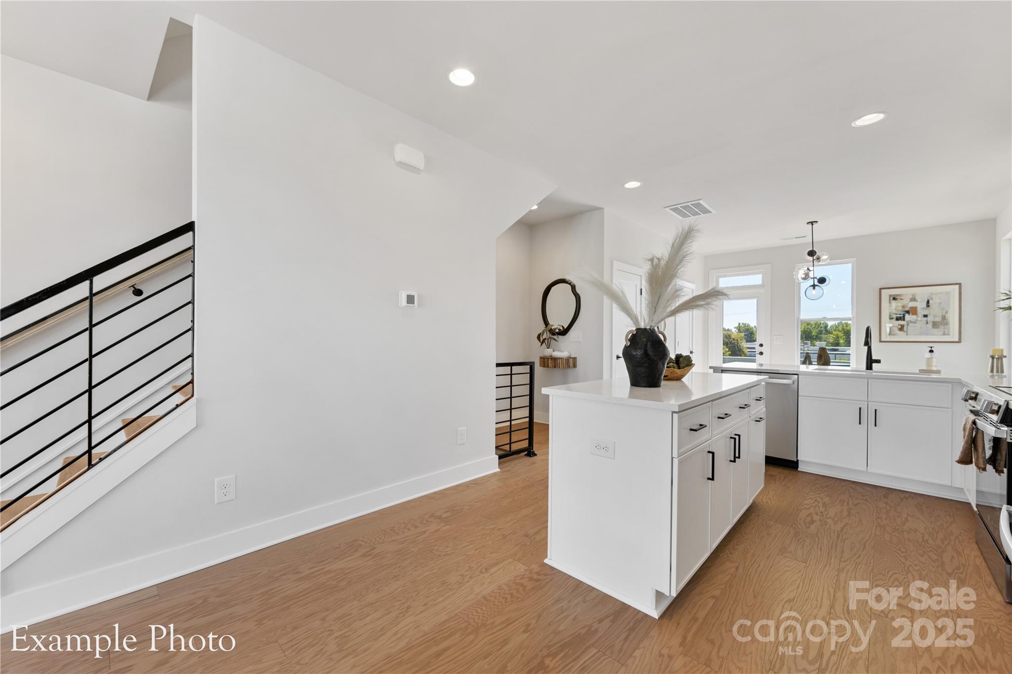 548 Rountree Road, Unit 9 Charlotte, NC 28217 - Photo 12 of 36 a kitchen with white cabinets and sink