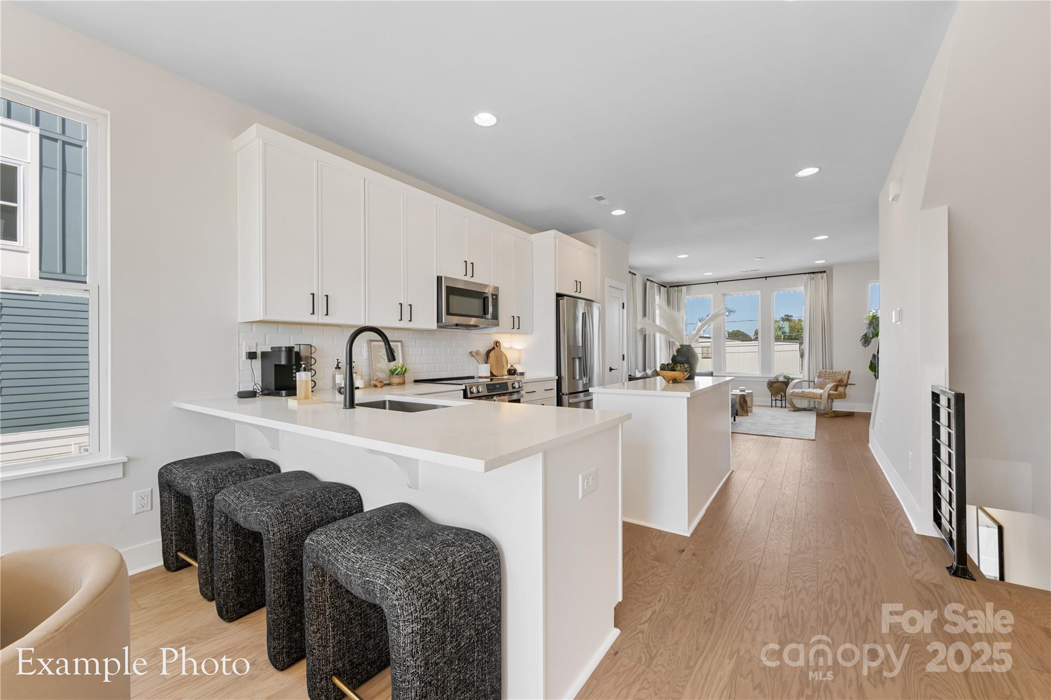 548 Rountree Road, Unit 9 Charlotte, NC 28217 - Photo 14 of 36 a view of kitchen with stainless steel appliances granite countertop a sink a stove a refrigerator cabinets and living room view