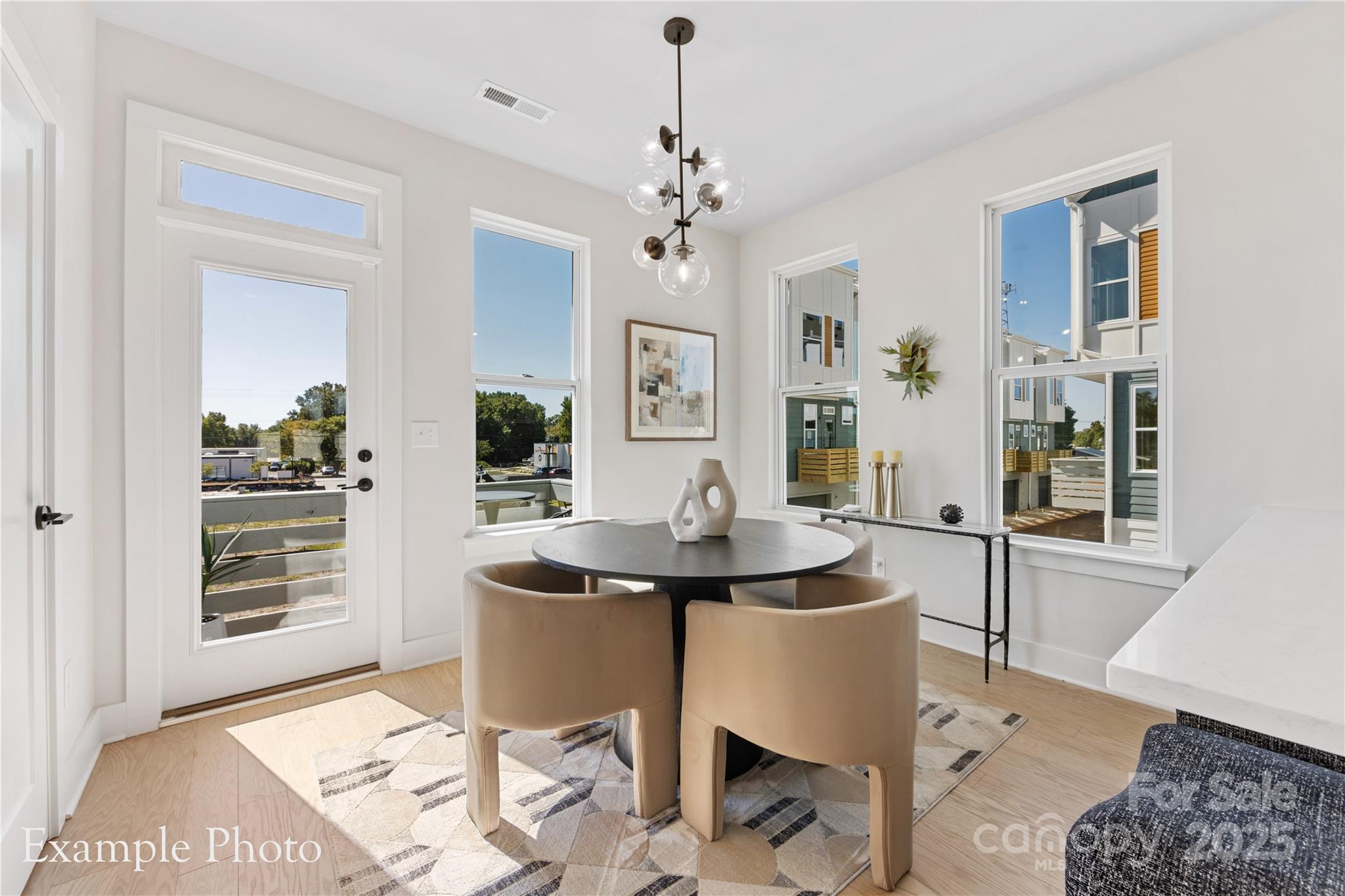 548 Rountree Road, Unit 9 Charlotte, NC 28217 - Photo 15 of 36 a living room with a couch and a chandelier