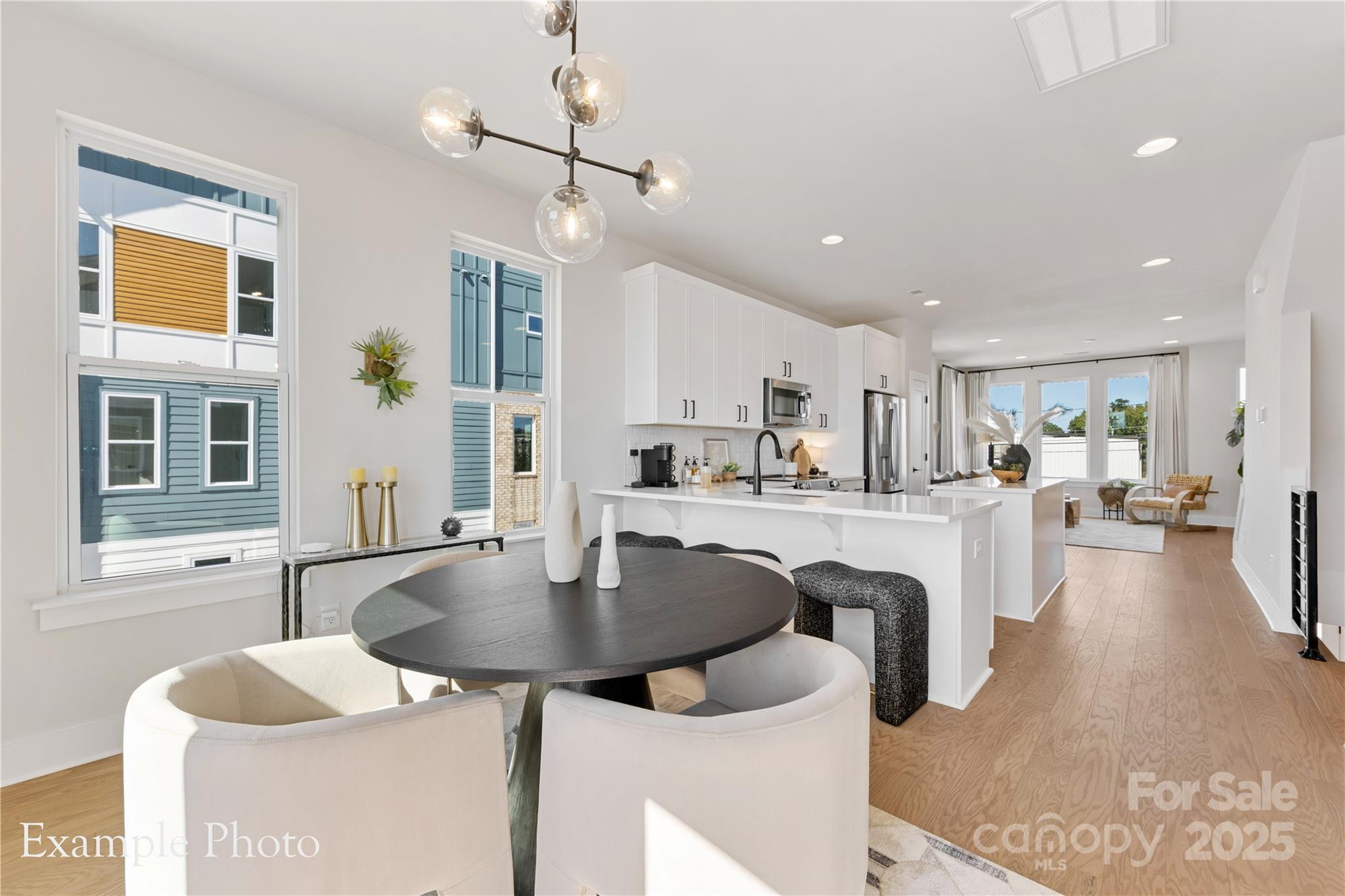 548 Rountree Road, Unit 9 Charlotte, NC 28217 - Photo 16 of 36 a kitchen with center island table and chairs