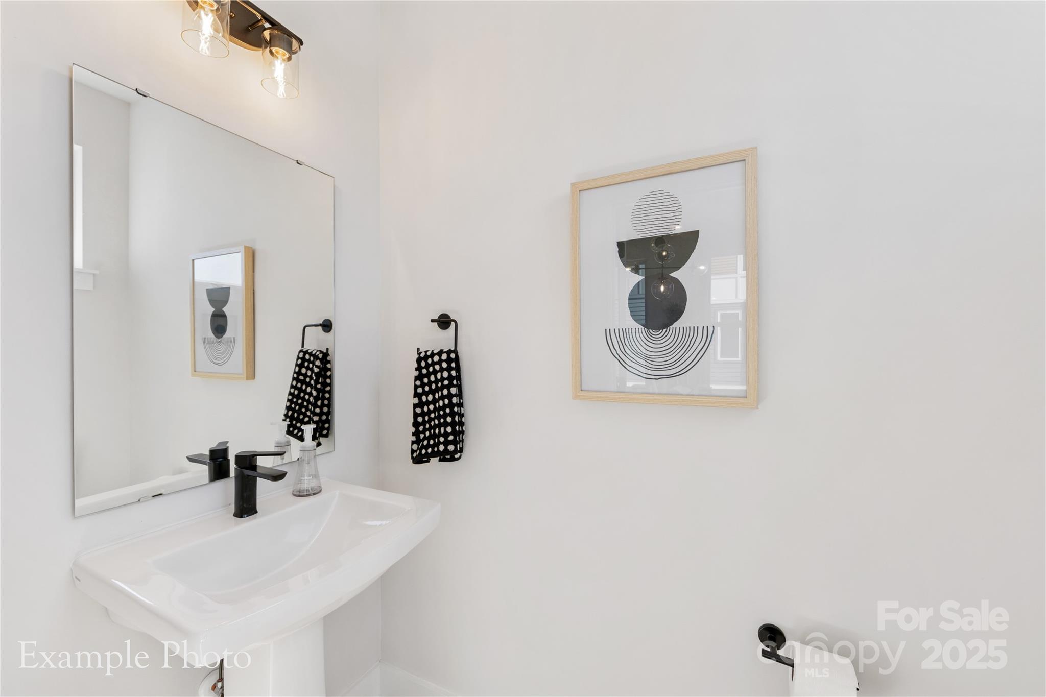 548 Rountree Road, Unit 9 Charlotte, NC 28217 - Photo 19 of 36 a bathroom with a sink a mirror and vanity