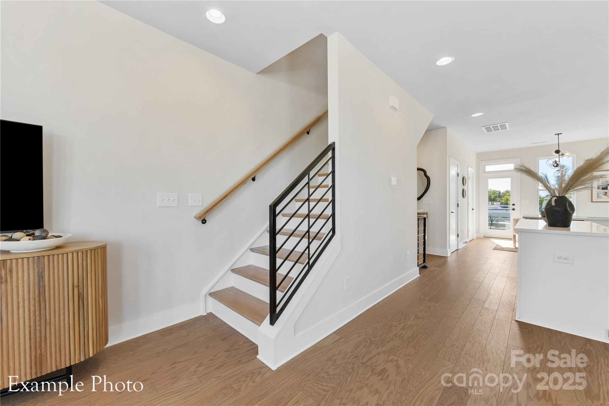 548 Rountree Road, Unit 9 Charlotte, NC 28217 - Photo 20 of 36 a view of a livingroom with wooden floor and stairs