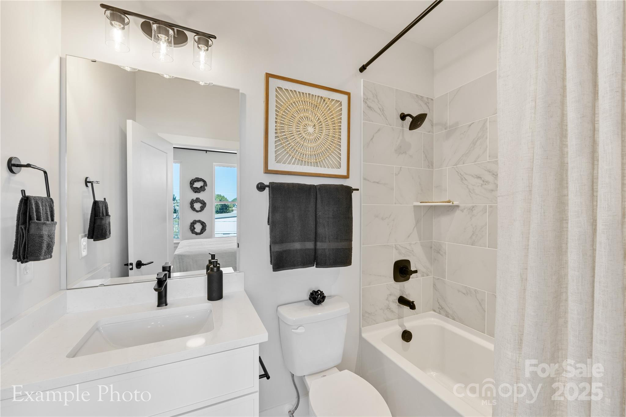 548 Rountree Road, Unit 9 Charlotte, NC 28217 - Photo 29 of 36 a bathroom with a bathtub sink and mirror