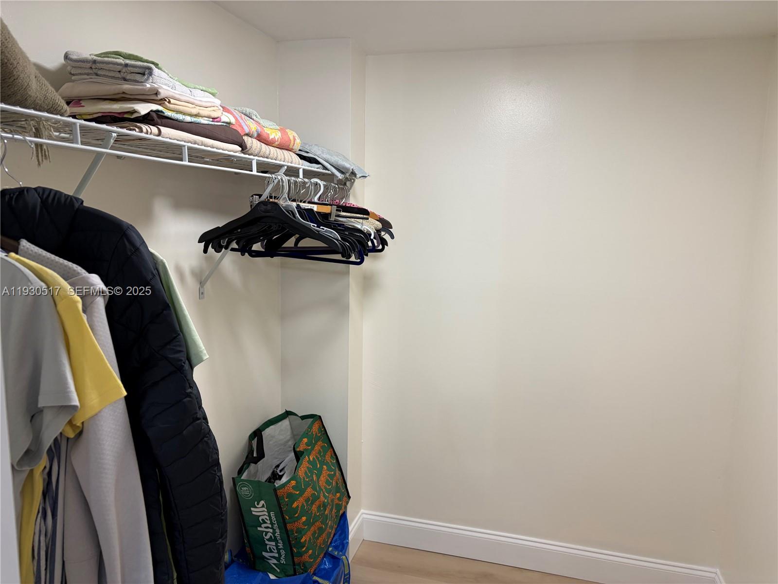 5550 Northwest 44th Street, Unit 414B Lauderhill, FL 33319 - Photo 13 of 17 a view of walk in closet with clothes and shoes