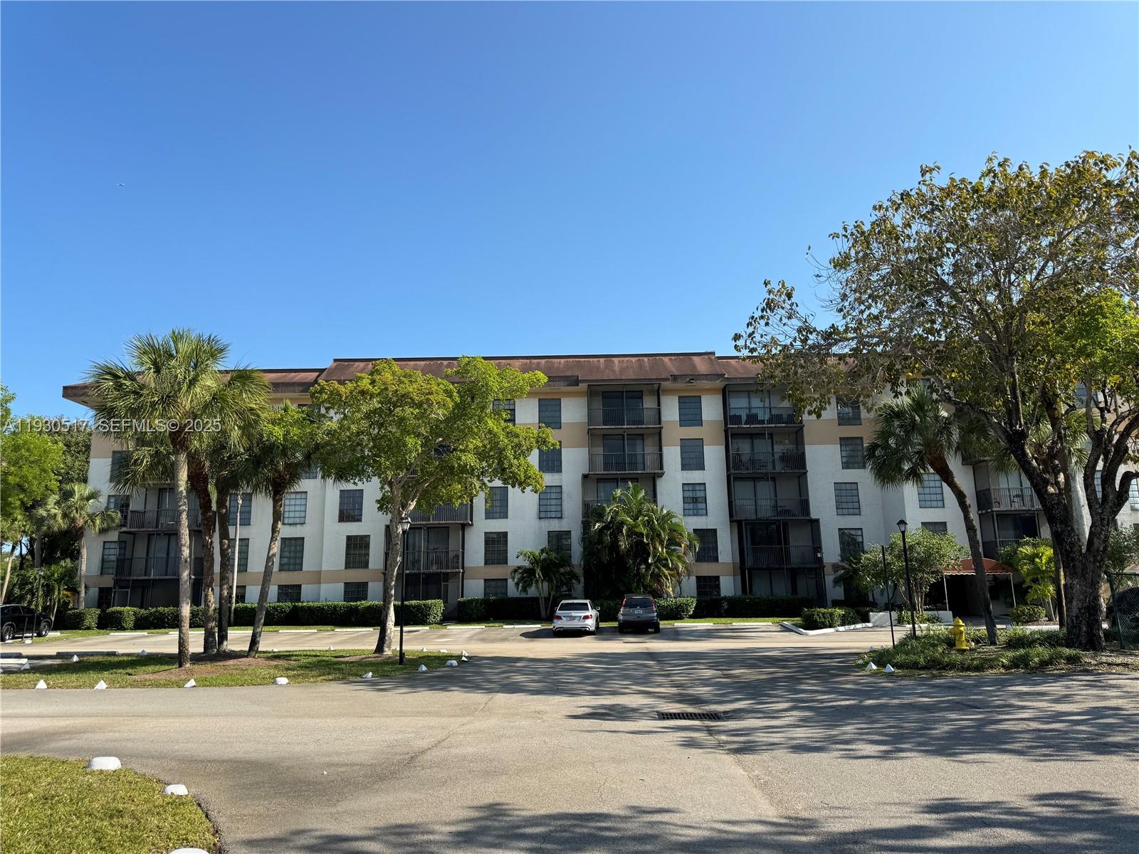 5550 Northwest 44th Street, Unit 414B Lauderhill, FL 33319 - Photo 17 of 17 a view of a house with a street