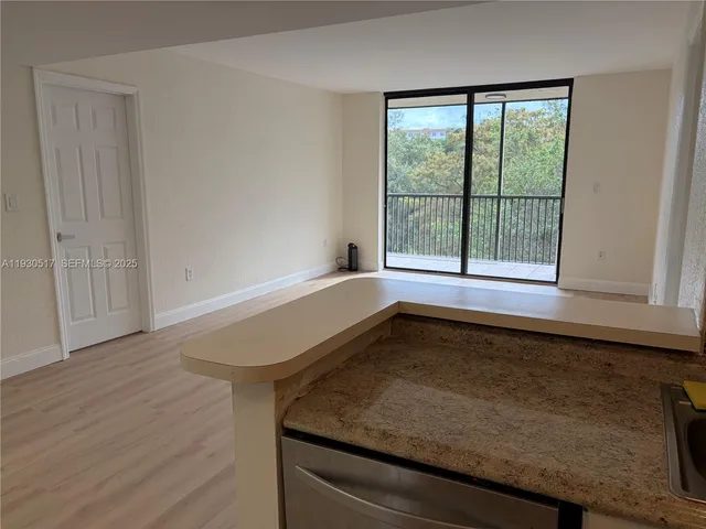 a bathroom with a granite countertop sink and window