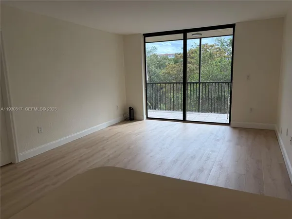 a view of a room with wooden floor and balcony