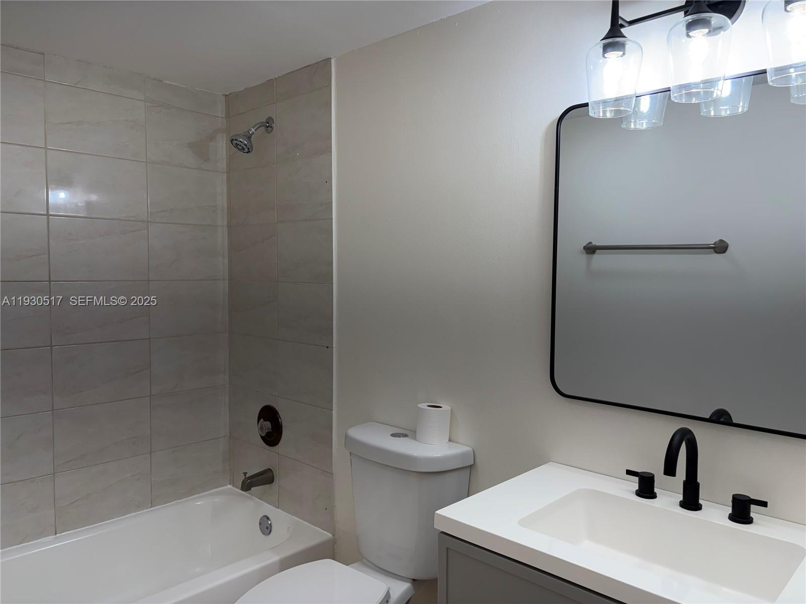 5550 Northwest 44th Street, Unit 414B Lauderhill, FL 33319 - Photo 8 of 17 a bathroom with a sink a toilet and shower