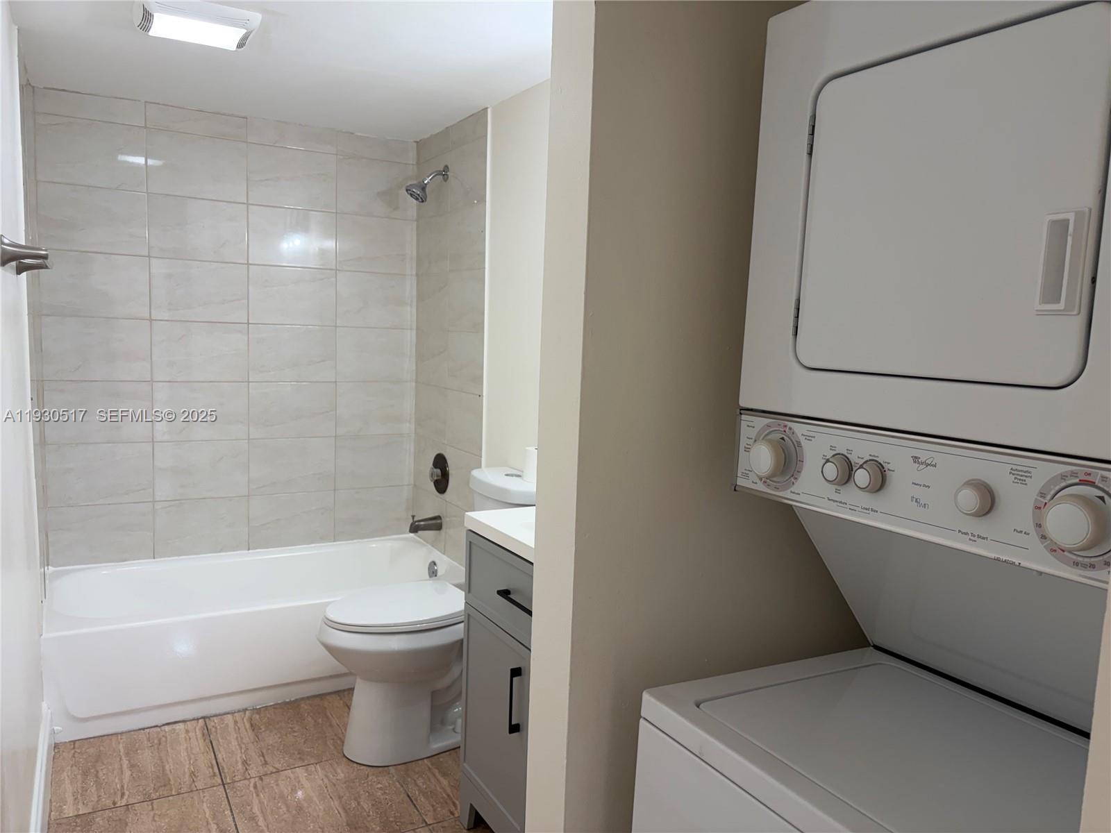5550 Northwest 44th Street, Unit 414B Lauderhill, FL 33319 - Photo 9 of 17 a bathroom with a toilet and a bathtub