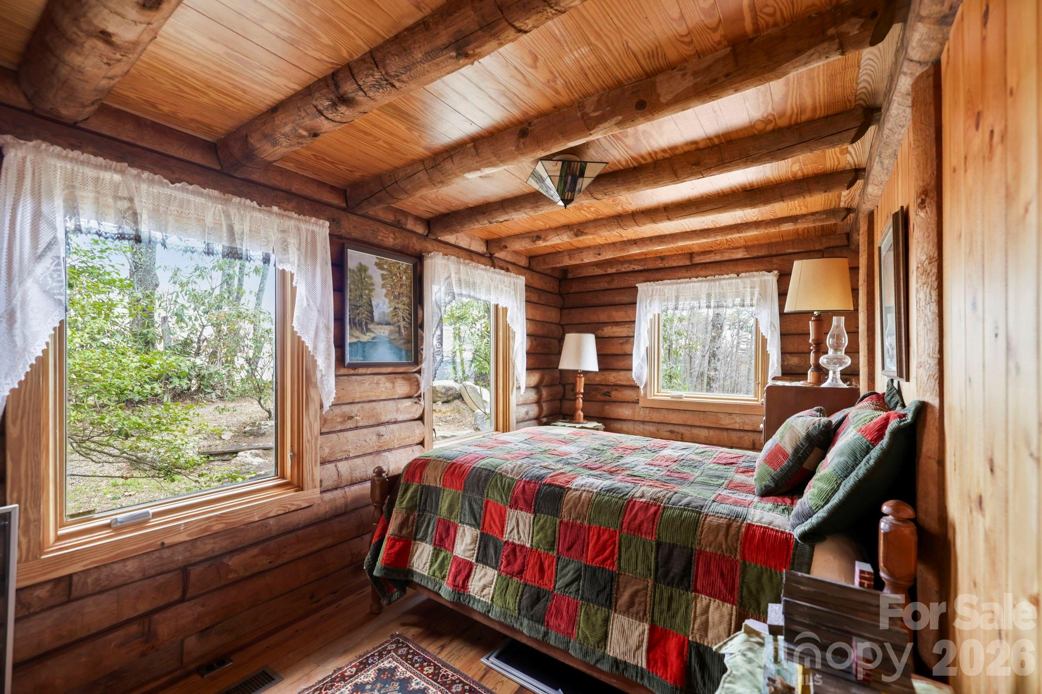 305 Stamey Creek Road Brevard, NC 28712 - Photo 11 of 32 a bedroom with a bed and wooden floor